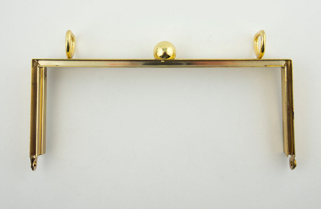 Close-up of the ball clasp on the gold shoulder bag frame