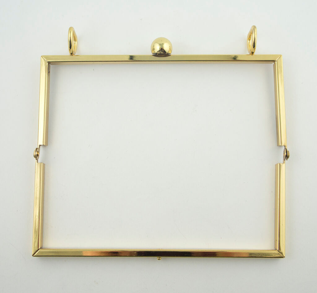 Flat lay of the gold tone shoulder bag frame measuring 175 x 75 mm