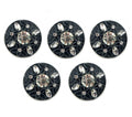 Close-up of embossed flower pattern on black button