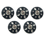 Close-up of embossed flower pattern on black button