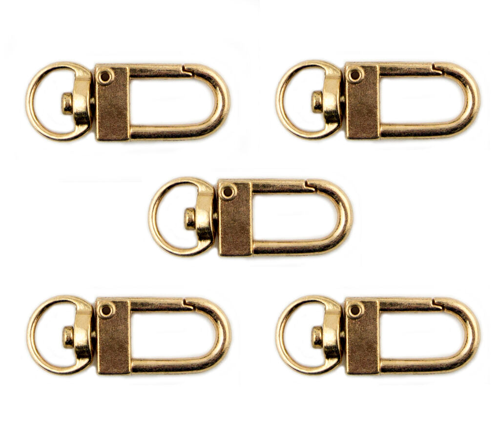 Five gold tone metal snap hook clasps displayed together.