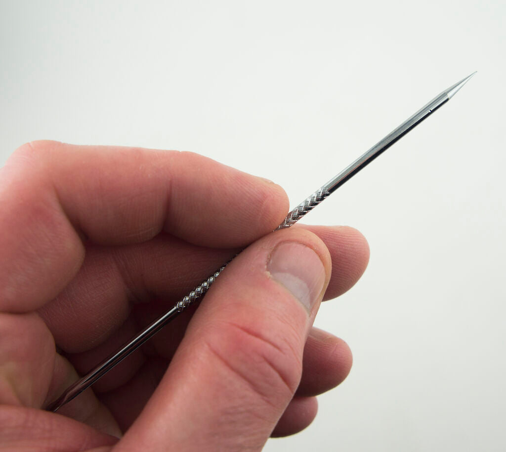 Close-up of stainless steel blackhead remover tools.