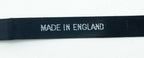 Close-up of satin label showing black background and white text.