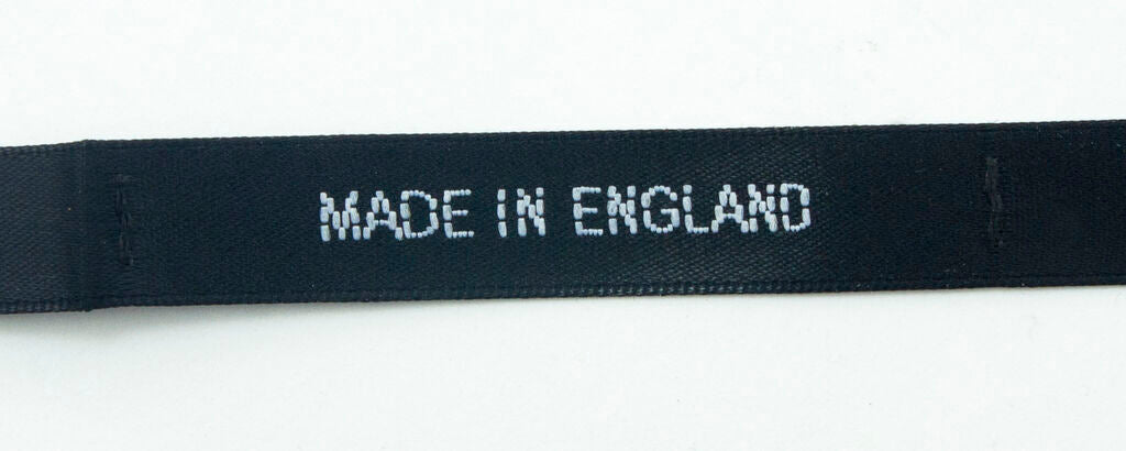 Close-up of satin label showing black background and white text.