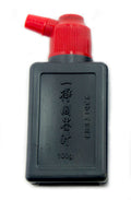Bottle of black sumi ink for calligraphy and drawing.