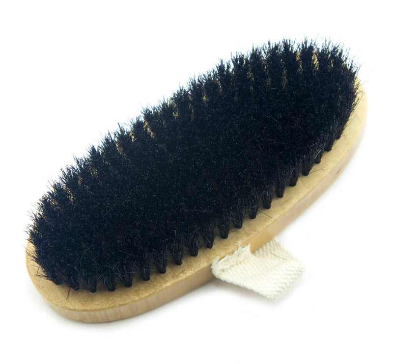 Large oval wooden brush with fabric loop for easy handling.