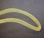 Close-up of lightweight millinery crin trim in egg yolk yellow.