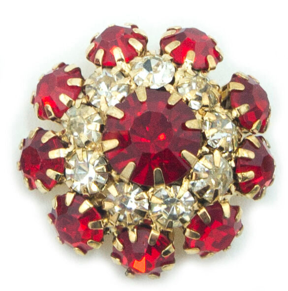 Red crystal buttons displayed on a fabric background
