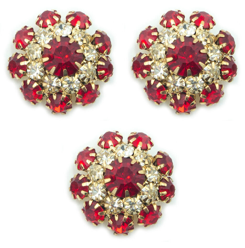 Three red crystal buttons in a gold tone setting