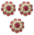 Three red crystal buttons in a gold tone setting