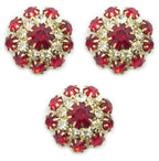 Three red crystal buttons in a gold tone setting