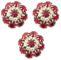 Three large red crystal buttons in a gold tone setting.