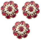 Three large red crystal buttons in a gold tone setting.