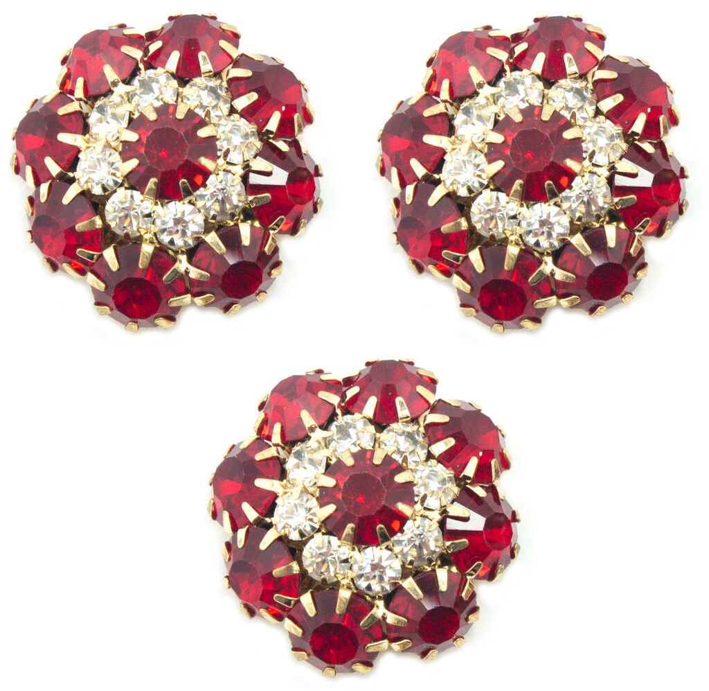Three large red crystal buttons in a gold tone setting.