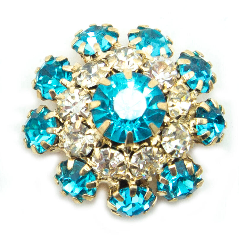 Display of marine blue crystal buttons on a fabric background.
