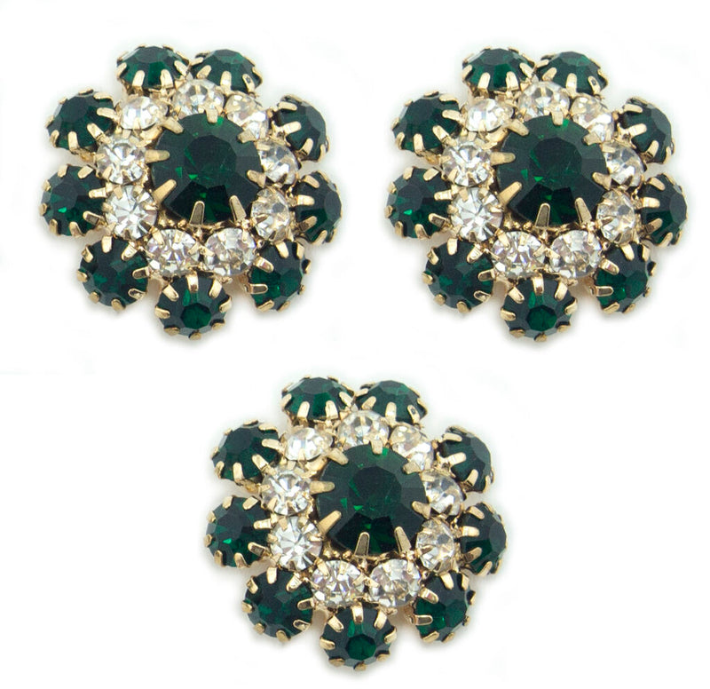 Three emerald green crystal buttons in a metal setting
