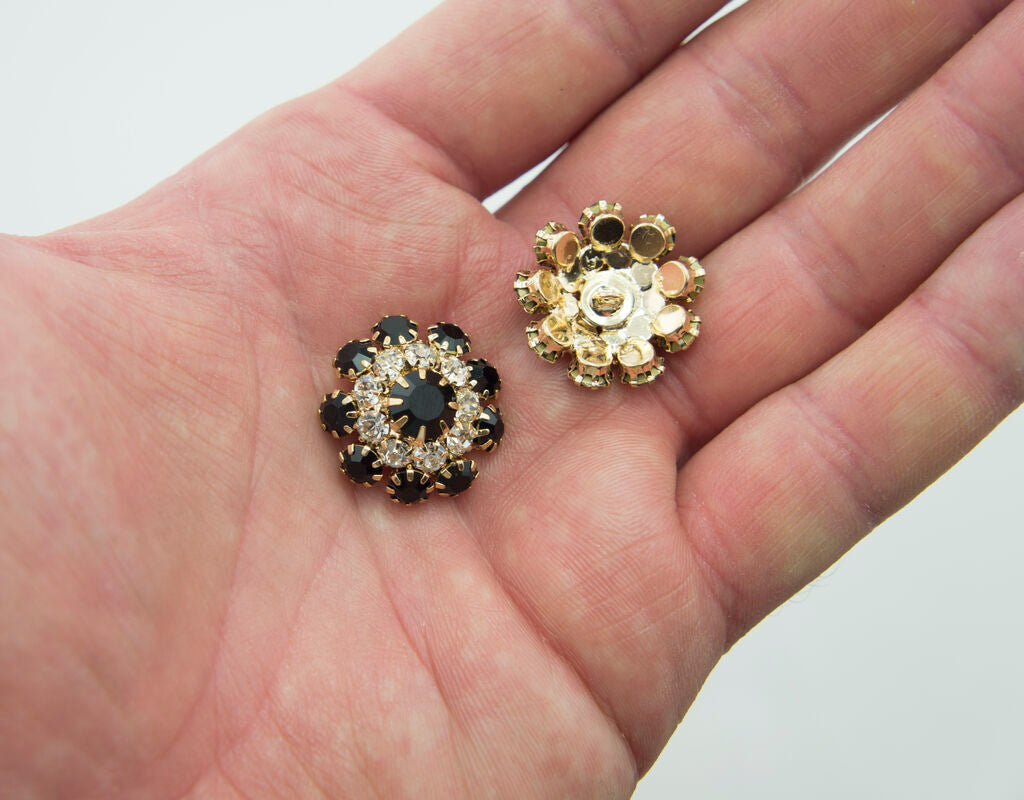 Close-up of a black and clear crystal button, 20 mm diameter.
