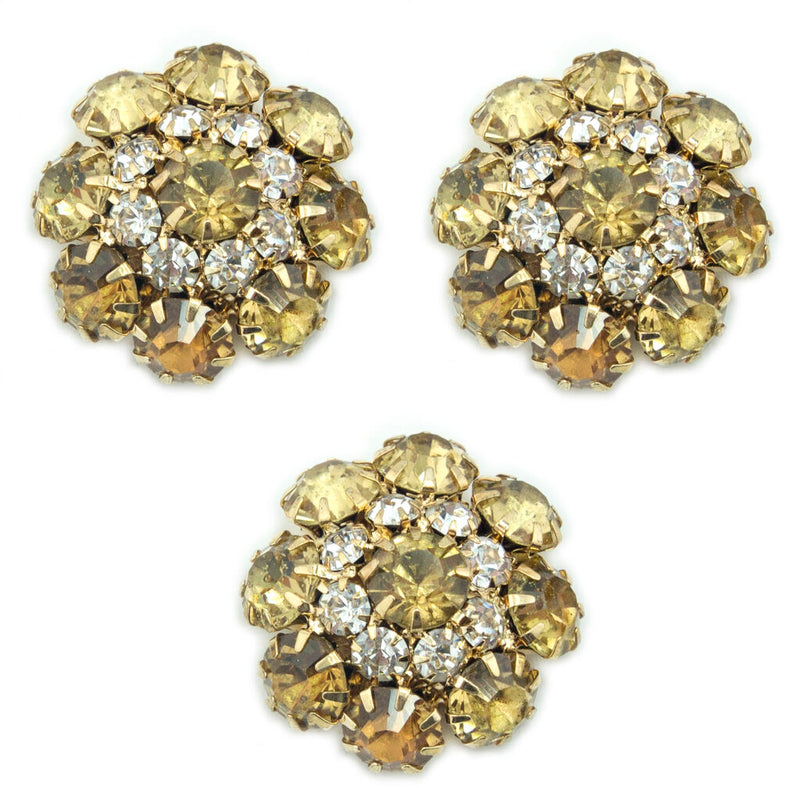 Three amber yellow crystal buttons in a gold tone setting.