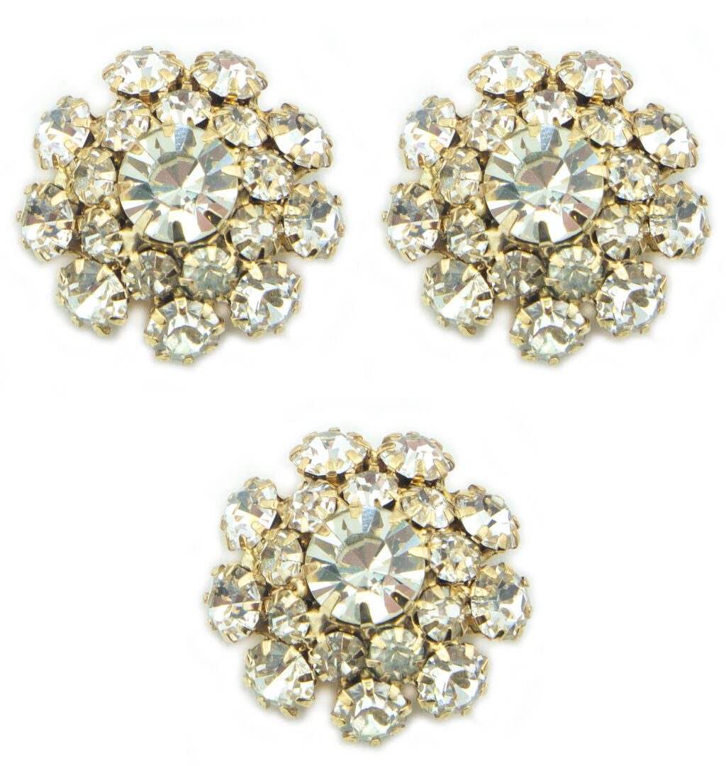 Three clear crystal buttons in a gold tone setting