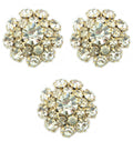 Three clear crystal buttons in a gold tone setting