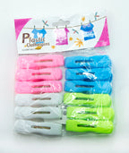 Display of pink and green plastic clothes pegs on a white background
