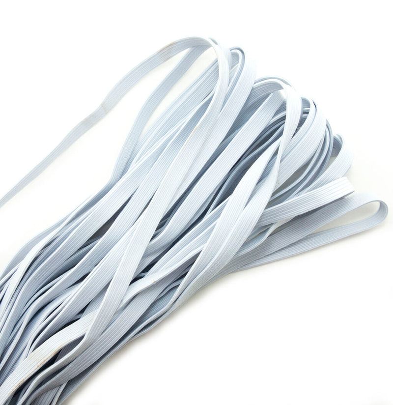 Roll of white flat sewing elastic 10 mm wide on a table.