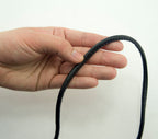 Close-up of 5 mm wide black PU trim piping for sewing projects.