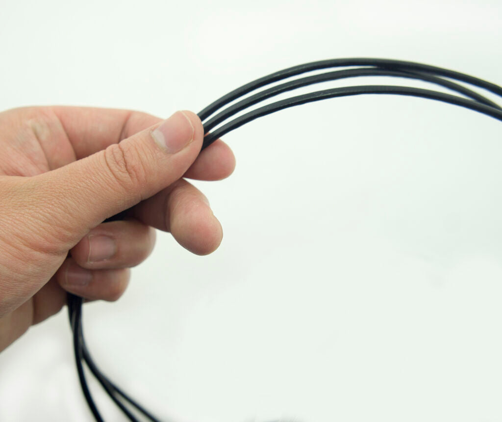 Close-up of 3mm wide black invisible seam trim for crafting.