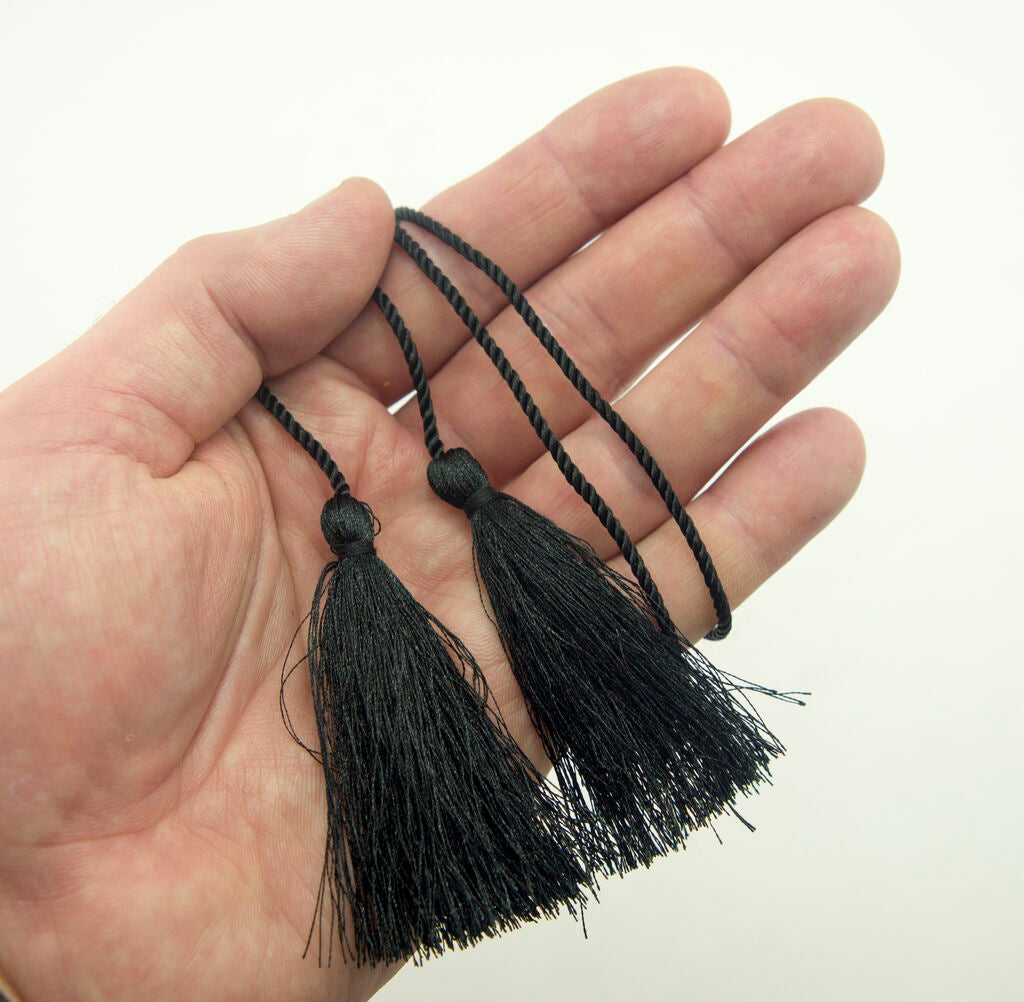 All four black tassels arranged neatly together