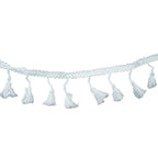 White cotton tassel trim displayed on a flat surface.