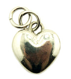 Close-up of a silver tone heart shaped pendant zip pull.