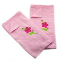 Pastel pink hand towel featuring an embroidered floral design.