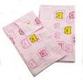 Set of 2 pink cotton face cloths for kids with Happy Baby motif.