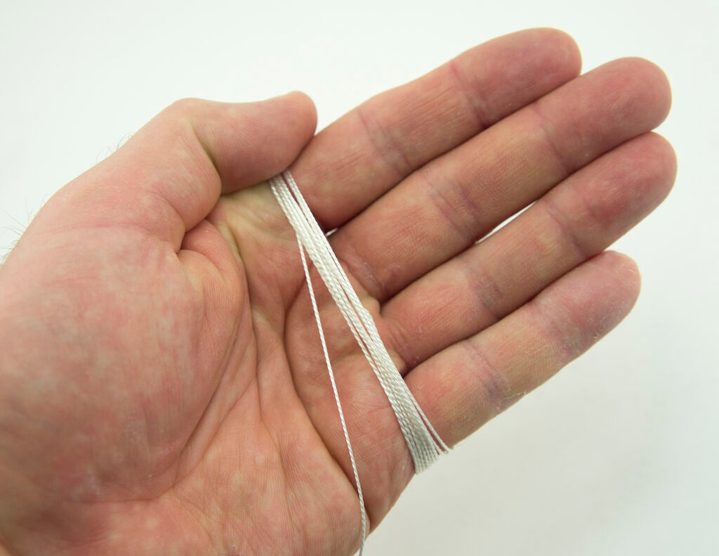 20 metres of white nylon thread displayed on a table