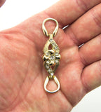 Close-up of the gold tone flower embellishment with white crystals.