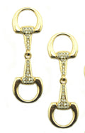 Gold tone equestrian buckle with white crystals on display.