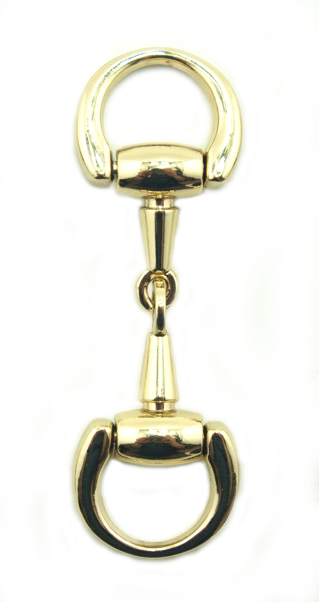 Polished gold equestrian buckles arranged with sewing materials.