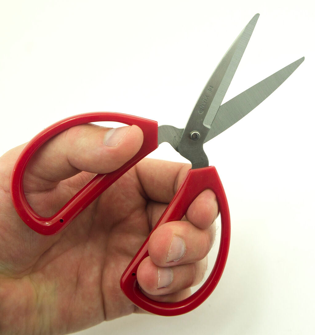 K12 scissors displayed with a measuring tape for size reference