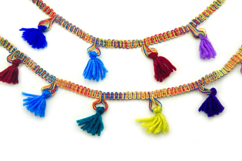 Mixed colours knitted tassel trim, 55mm wide, displayed on a roll.