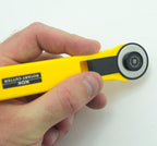 Close-up of the NDK RC-28 rotary cutter showcasing its ergonomic design.