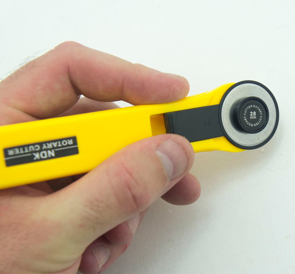 Close-up of the NDK RC-28 rotary cutter showcasing its ergonomic design.