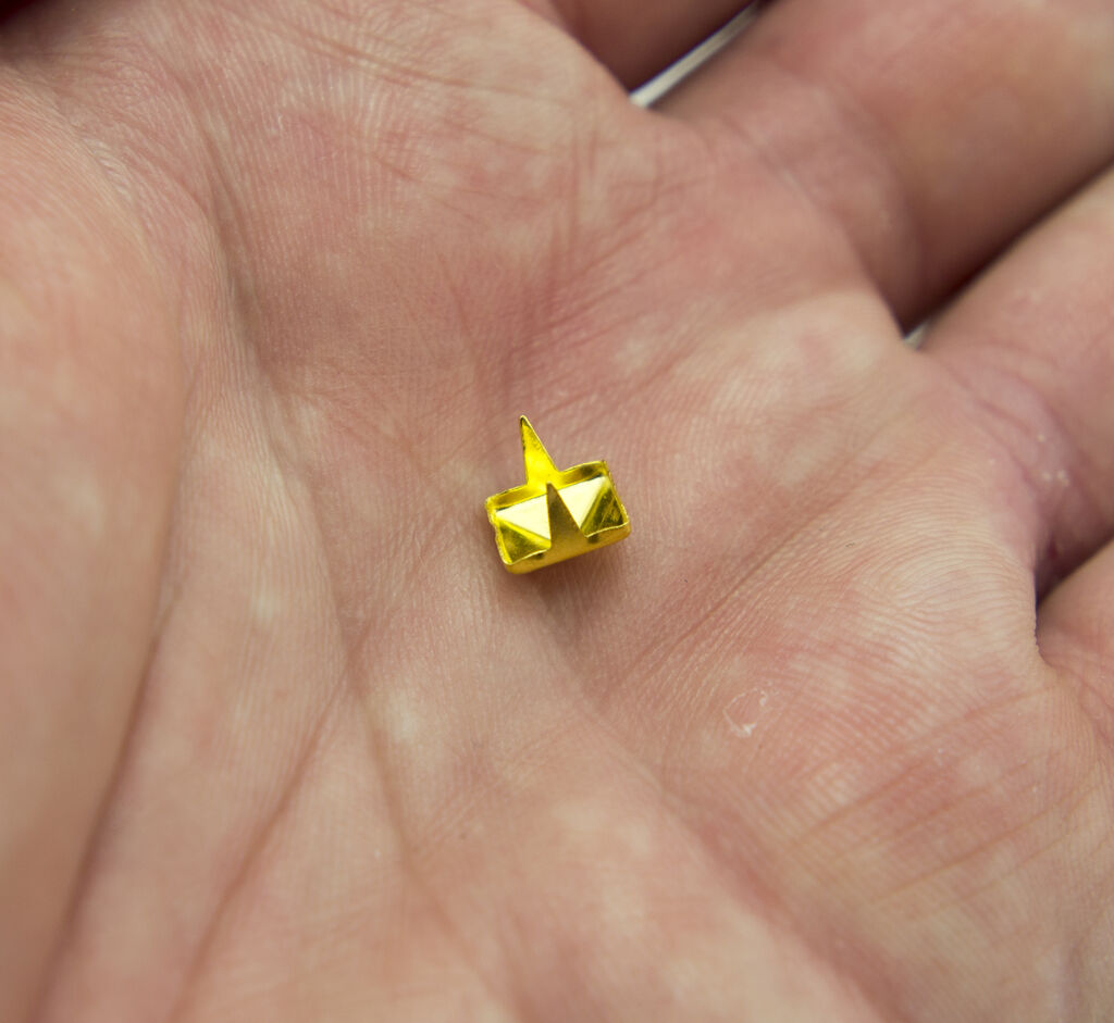 Pyramid studs displayed on a fabric background
