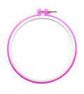 Pink plastic super grip embroidery hoop on a white background.
