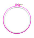 Pink plastic super grip embroidery hoop on a white background.