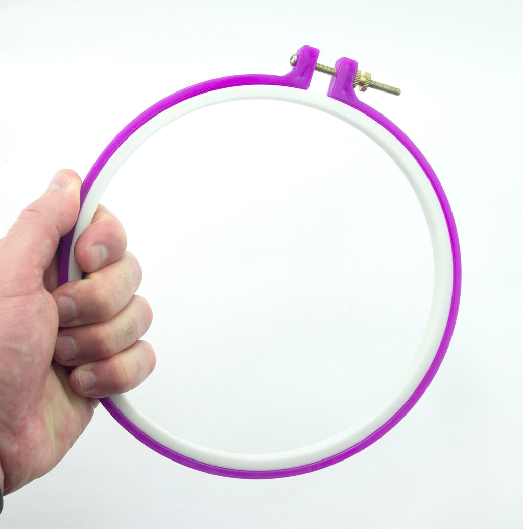 Different angles of the pink plastic embroidery hoop for crafting.