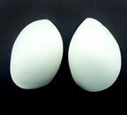 Close-up of XL white bra pads showing material texture.