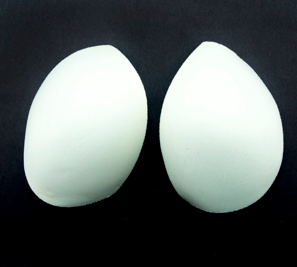 Close-up of XL white bra pads showing material texture.