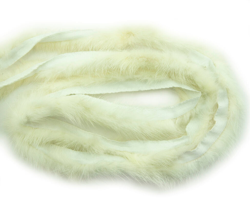 Thin white mink fur piping trim displayed on a flat surface