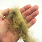 Fox fur piping trim being used on a garment edge for decoration.