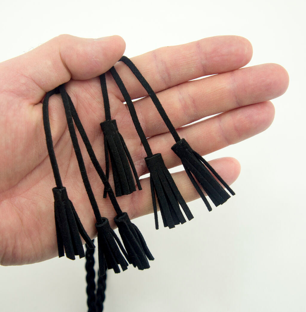 Close-up of the black suede texture and braided design.